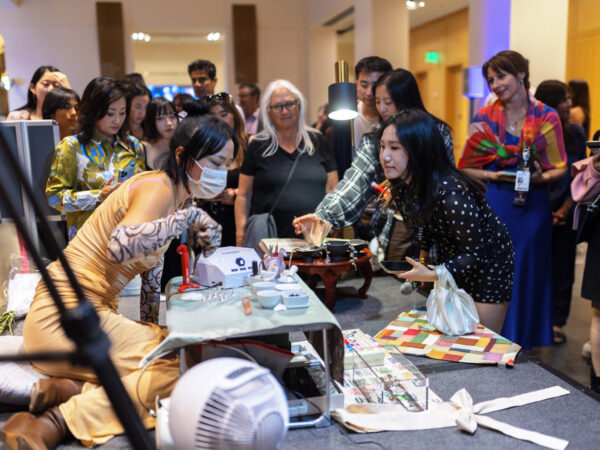 Members view a demonstration of gel nail artistry at the opening night celebration of Hallyu!